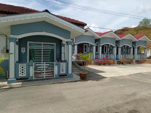 a row of houses on the side of a street at Ku's Roomstay in Pantai Cenang