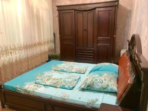 a bed with two pillows on it in a room at Cozy, large apartment in the heart of city center in Baku