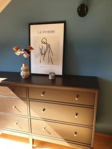 a dresser with a picture on top of it at Lindengut Natternbach in Natternbach