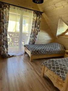 a room with two beds and a window in a cabin at Roomflacja Bałtyk in Sianozety