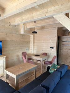 a living room with a blue couch and a table at Roomflacja Bałtyk in Sianozety +33 photos