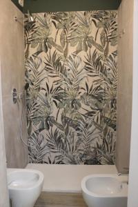 リヴォルノにあるHotel Aristonの黒と白の壁紙を使用したバスルーム