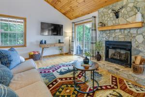 a living room with a couch and a fireplace at Mtn-View Escape with Hot Tub, 9 Mi to Skiing! in Maggie Valley