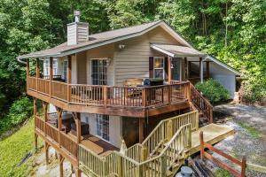 a house with a large deck and a porch at Mtn-View Escape with Hot Tub, 9 Mi to Skiing! in Maggie Valley