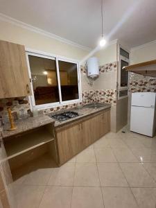 a kitchen with a counter top and a refrigerator at Logement entier : Appartement à Agadir in Agadir