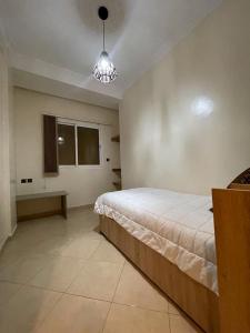 um quarto com uma cama grande e uma janela em Logement entier : Appartement à Agadir em Agadir
