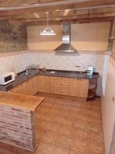 a kitchen with a sink and a stove top oven at Agroturismo Biltegi Etxea 