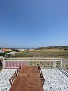 a wooden deck with benches on top of a balcony at DENİZE 5 DAKİKA VE DOĞA EVİ in Cesme +8 photos