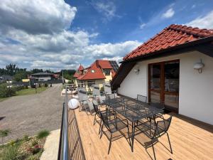 patio ze stołem i krzesłami na pokładzie w obiekcie APARTAMENT PIEKOSZOWSKA Targi Domek Parking w Kielcach