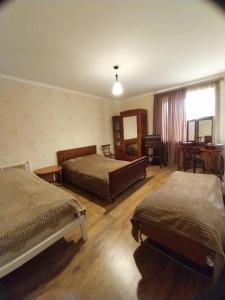 a bedroom with two beds and a table and a window at Em&Ri Guest House in Odzun in Odzun