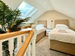 a attic bedroom with two beds and a skylight at 59 Moss Green - Close to the city centre in York
