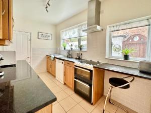 a kitchen with a sink and a stove at 59 Moss Green - Close to the city centre in York