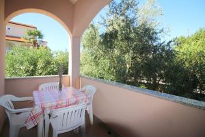 balkon ze stołem i krzesłami oraz oknem w obiekcie Apartment in Porec 10 w Poreču