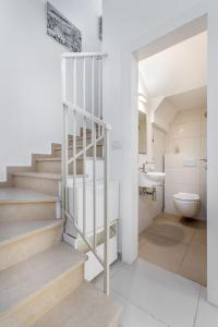 a bathroom with stairs and a toilet and a sink at Trust Inn garden in the city in Tel Aviv