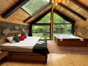 a bedroom with a bed and a bath tub at Ayder Hasimoglu Hotel in Ayder Yaylasi