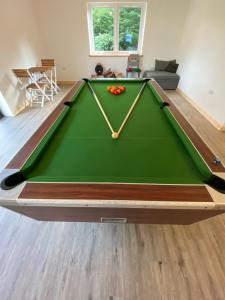 a pool table in the middle of a living room at Luxury Railway carriage with own private hot tub in Clodock