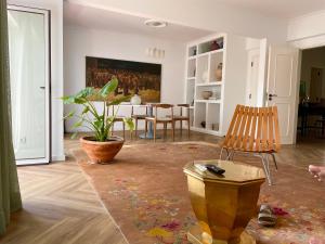 a living room with a table and a chair at Loulé Old Town Apartment in Loulé