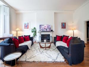 a living room with two couches and a fireplace at Pass The Keys Perfect Blend of Comfort Charm in London