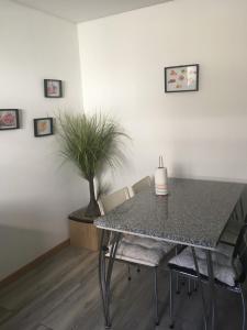 a dining room table with chairs and a candle on it at Casa do Castelo I in Bragança