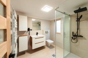 a bathroom with a shower and a toilet and a sink at Terra Resort in Topliţa