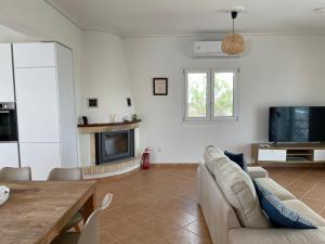 a living room with a couch and a table at Villa Valleyview Methoni in Methoni