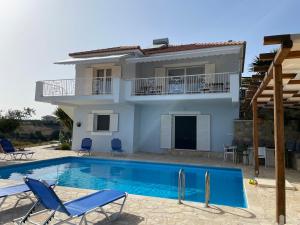a villa with a swimming pool and a house at Villa Valleyview Methoni in Methoni