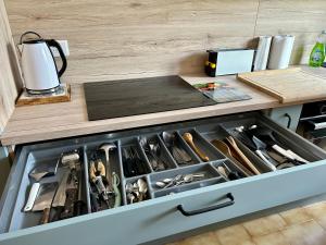 a drawer in a kitchen filled with lots of tools at Les oliviers du pradon in Lagarde-Paréol
