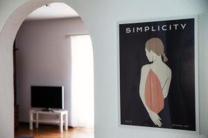 ein Bild einer Frau auf einem Plakat an einer Wand in der Unterkunft Victoria Apartment by Quokka 360 - simple and practical flat in Locarno in Solduno