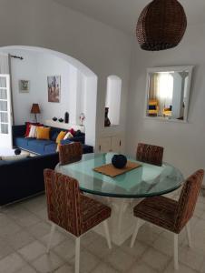 a living room with a glass table and chairs at Villa de Charme Adultes Only in Nabeul