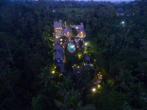 an aerial view of a resort at night at The Kayon Resort in Ubud