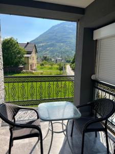 two chairs and a table on a balcony with a view at Duča Apartmani in Plav