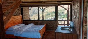 a bedroom with a bed with a sink and a window at Dana Gate Lodge in Dana