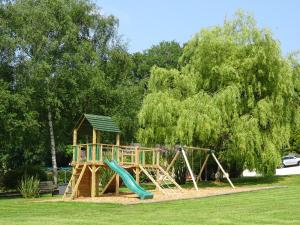 a playground with a slide in a park at Alpine Park Cottages in Aylesbeare
