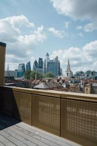 a view of a city skyline from a balcony at Access Brick Lane in London