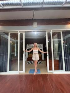 a woman standing in the doorway of a house at Kubu Kawi in Munduk