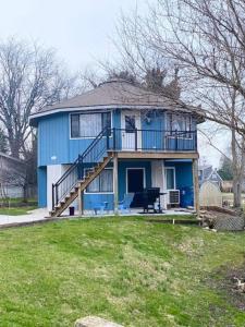 Casa azul con porche y balcón en Unique Octagon House near Cedar Point, en Huron