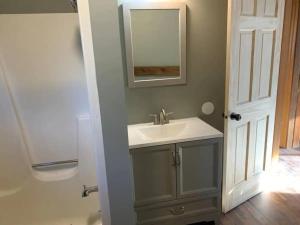 y baño con lavabo y espejo. en Unique Octagon House near Cedar Point, en Huron