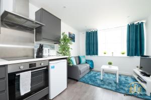 a kitchen and living room with a couch at Atlas Apartment - The Pillar of Town in Southampton