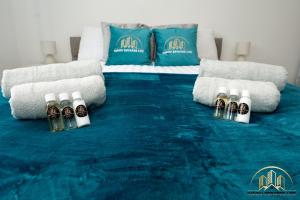 a blue carpet with bottles of alcohol on a bed at Atlas Apartment - The Pillar of Town in Southampton