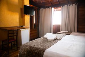 Säng eller sängar i ett rum på Dunas de Itaipu