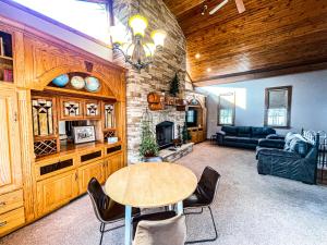 a living room with a table and a fireplace at Charming School House with Large Pool in Huron
