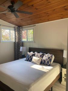 a bedroom with a bed with a ceiling fan at Newly Renovated! Old Homestead Beach Home in Huron