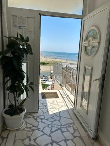 an open door to a balcony with a view of the beach at Apartments Doda in Ulcinj