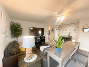 a living room with a couch and a table at Side-by-Side Family Apartments - Sleeps 15 Total in Huron