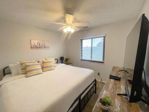 a bedroom with a bed and a ceiling fan at Side-by-Side Family Apartments - Sleeps 15 Total in Huron