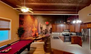 a kitchen with a pool table in the middle of it at The Jazz Club in Sandusky