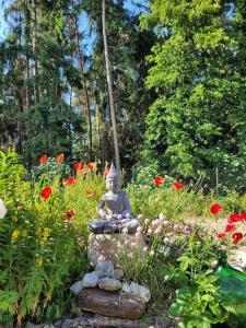 eine Statue inmitten eines Gartens mit Blumen in der Unterkunft Urlaubstraum am Brombachsee- 5 stilvolle Zimmer- in Pleinfeld