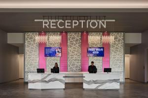 two people sitting at a reception desk in a lobby at Great Canadian Casino Resort Toronto in Toronto