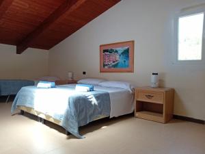 a bedroom with two beds and a window at Santa Pigna in Centola