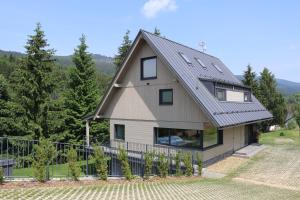 a house with a metal roof at Chata Jestřábník in Dolní Morava